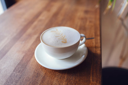 Cappuccino coffee close up in the making above wooden table. life style photoの写真素材