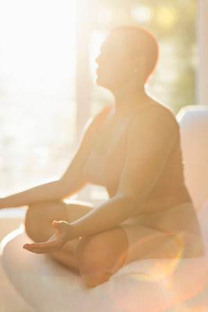 Happy young caucasian bald woman in light sunny room. Beautiful excited female model. Human...