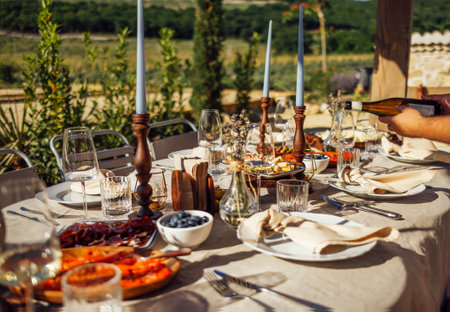 Wedding. Banquet. Chairs and a table for guests, decorated with candles, are served with cutlery and...