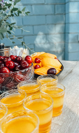 Glasses of cocktails on the bar. Glasses of sparkling wine with red alcohol. Preraring aperol spritz cocktail in outdoor summer barの写真素材
