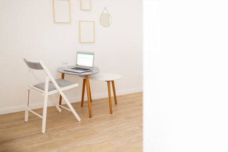 Background of minimal home office workplace in modern apartment decorated with abstract art, copy space. Mock upの写真素材