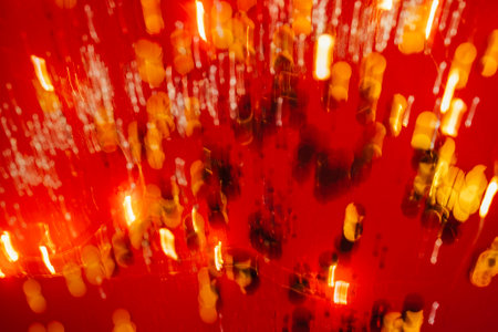 Red tone blurs the bokeh light. Defocused Red and orange holiday bokeh. abstract christmas...