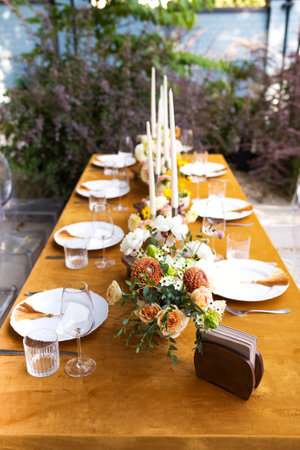Wedding. Banquet. Chairs and a table for guests, decorated with candles, are served with cutlery and...