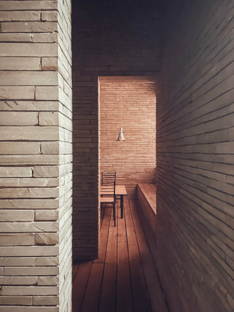 Natural interior of rooms with brick walls and wooden floor. minimalism. Wooden furniture and metal lampshade. perspective. copyspace.の写真素材