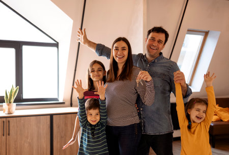 house ownership. Portrait Of Happy Young family Holding Showing Key Standing In New Flat, Cheerful...