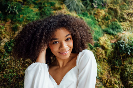 Fashion and beauty shooting a charming mixed race girl in a long white dress. Beautiful girl on the...