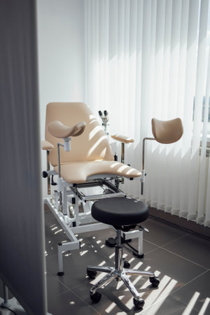 Gynecological chair. Modern bright office of the gynecologist. Sunny day.の写真素材