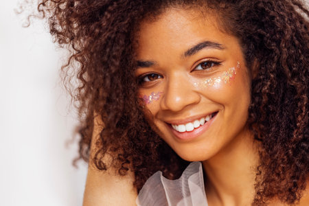Female portrait of attractive darkskin girl smiling and posing for camera. Charming african american...
