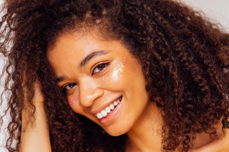 Female portrait of attractive darkskin girl smiling and posing for camera. Charming african american...