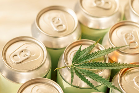 A collection of aluminum cans with a cannabis leaf. Trending concept of CBD-infused beverages with hemp. Eco-friendly packaging and wellness industry.の写真素材