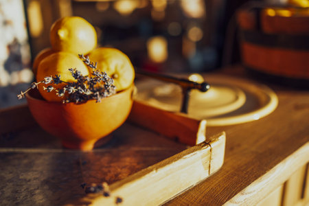 Extreme closeup of vertical view of a wooden bucket full of fresh lemons and sprig of lavender....