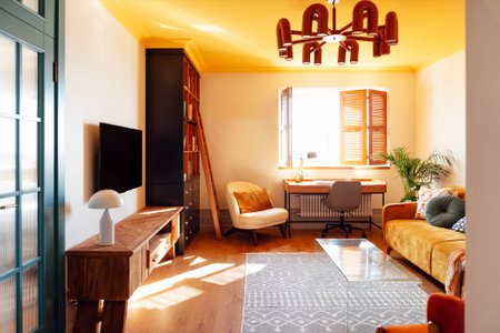 An elegant armchair made of orange fabric and wooden elements. Modern living room with wooden furniture. Bright sunlight. Stylish blue bedroom doorの写真素材