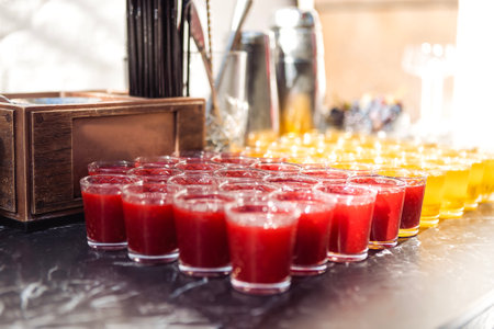 Smooth rows of glasses with delicious refreshing berry and fruit drinks. Fresh fragrant cocktails on...