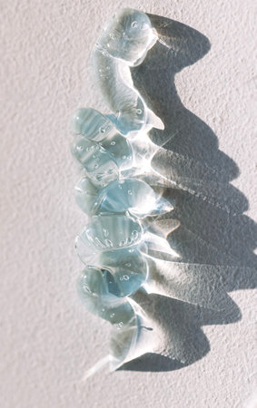 Close-up of a transparent blue gel with bubbles. Cosmetic products. Serum or essences on a textured...