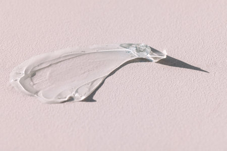Close-up of a transparent gel smear with bubbles. Cosmetic products. A drop of serum or essence on a...