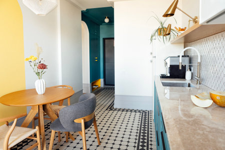 Fashionable modern kitchen in blue and white tones. The cozy interior of the dining room with a...
