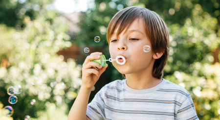 Child with brown hair is blowing bubbles in a sunny garden, surrounded by lush greenery, showcasing the playful spirit and joy of outdoor activities, AI generatedの素材
