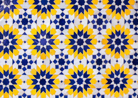 Vibrant geometric tile pattern showcases blue, yellow, and white colors, creating a striking visual...