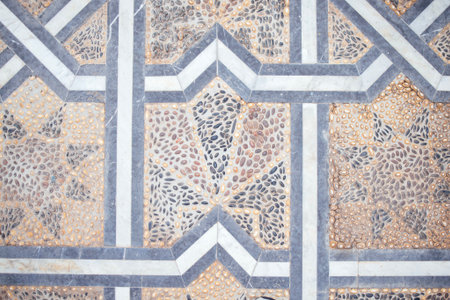 Detailed stone tile pattern showcases a mix of textures and colors, forming a beautiful geometric...