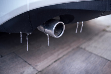 Detailed close-up of car exhaust pipe with icicles, highlighting winter weather effects on vehicles, showcasing cold conditions and automotive design elementsの写真素材