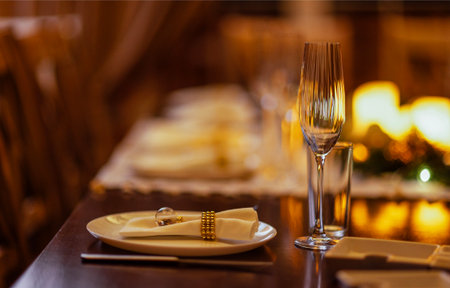 Beautifully arranged dining table features white plates, elegant glassware, and decorative napkins, enhancing the ambiance for a memorable dining experienceの写真素材