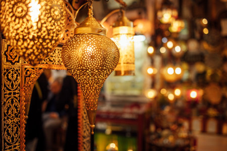 Beautiful golden lanterns are suspended in a lively market, illuminating the space with intricate...