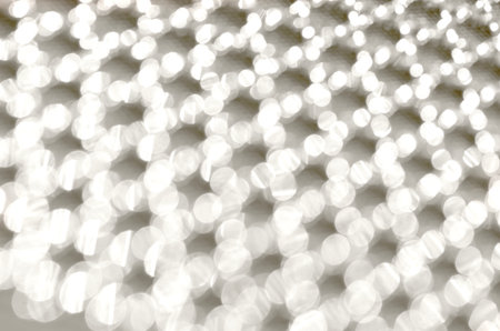 Abstract gold grid background. Beautiful vibrant mesh bokeh. The backdrop is made of shiny sequins....