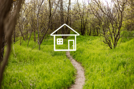 Pathway meanders through vibrant green grass towards a house illustration, framed by trees and foliage in a tranquil outdoor environment