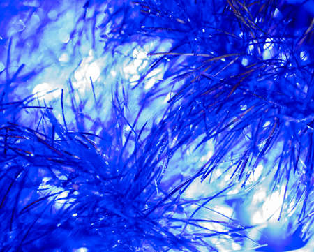 Bright shiny blue background of tinsel and bright garland