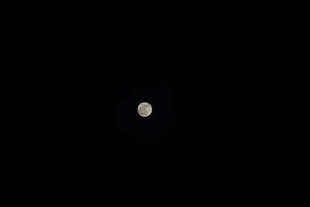 Little moon in deep dark sky without stars and clouds