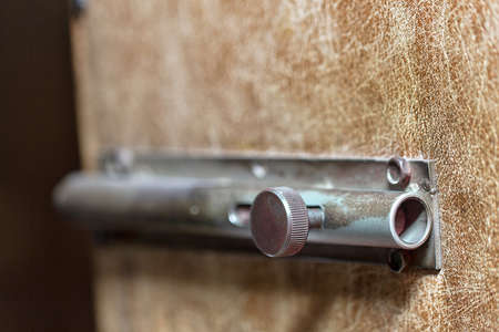 Big nice old iron latch on brown doorの写真素材