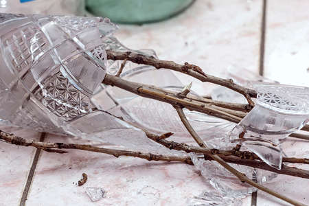 Brown tree branches in broken vase in homeの写真素材