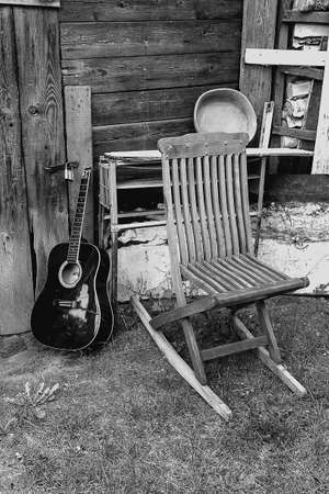 Old chair and guitar in garden black and whiteの写真素材