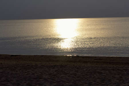 Beautiful gold sunset on pretty summer Baltic seaの写真素材