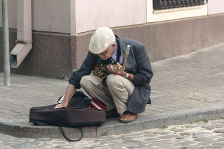 Street saxophonist is old men in old cityのeditorial素材