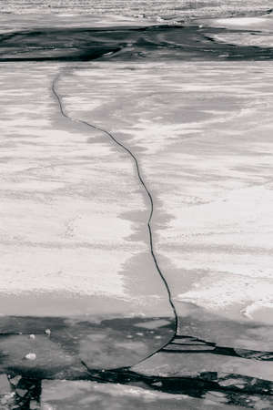 Big crack in spring ice of riverの写真素材