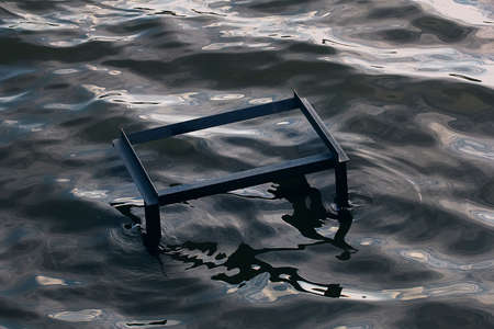 Strange metal construction in water in cloudy dayの写真素材