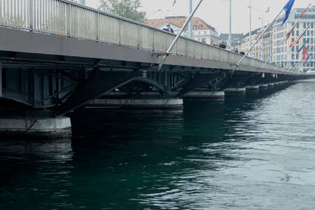 Nice bridge over river in Geneva at cloudy autumn dayの写真素材