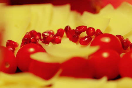 Cheese with tomatoes and pomegranate seeds for partyの写真素材