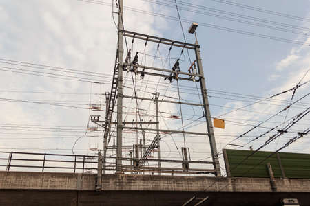 Railway electrical wiring in street at day
