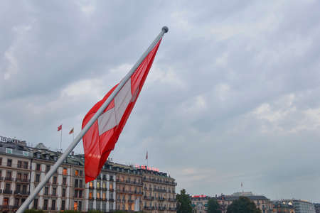 Nice red and white swiss flag in Geneva at autumn eveningのeditorial素材