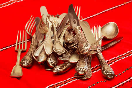 Nickel silver cutlery on red tablecloths, forks and knivesの写真素材