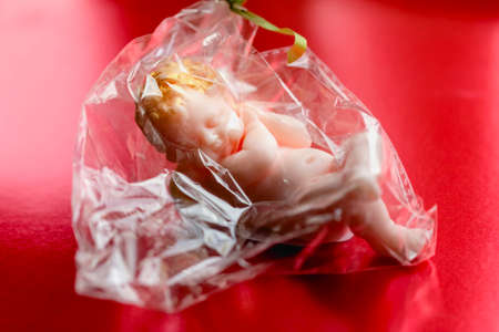 Nice soap in form of angel on red backgroundの写真素材