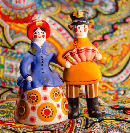 Beauty Dymkovo toy couple at multi color backgroundの写真素材
