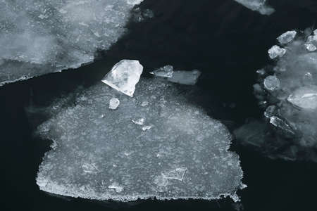Beauty winter ice on dark water in riverの写真素材