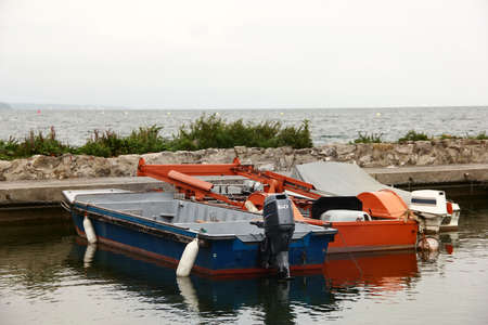 Motor working boats on water during autumn day