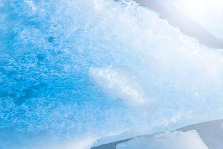 Beauty blue white ice dusting of snow in sunlightの写真素材