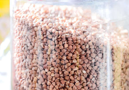 Nice brown buckwheat in glass jar at sunny dayの写真素材