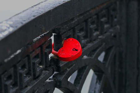 Nice red lock-heart on cast iron black fenceの写真素材