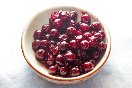 Ripe red berries josta in round platterの写真素材